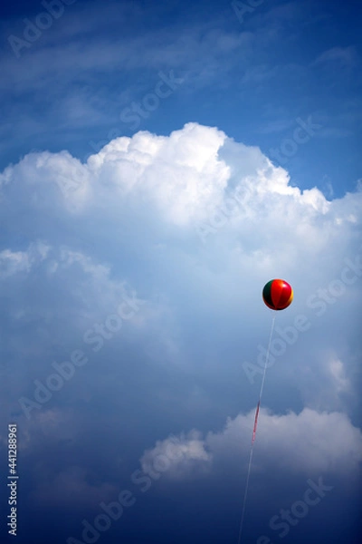 Fototapeta A colorful balloon yearning for freedom in the clear sky