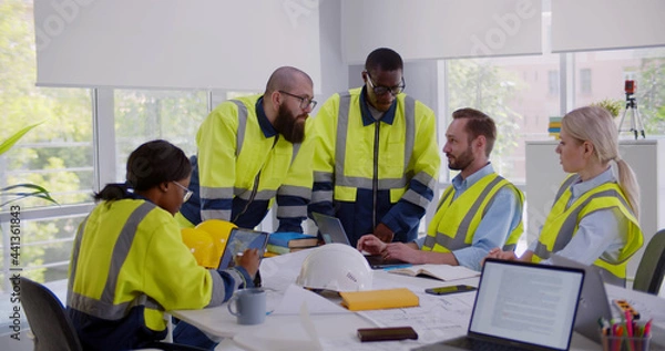 Fototapeta Multiracial engineers team meeting for architectural project in office