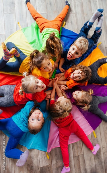 Obraz Cheerful children playing team building games on a floor