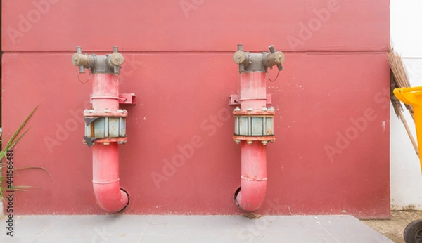 Obraz metal piping system on red concrete wall