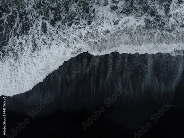 Fototapeta Abstract nature background. Aerial drone view of black sand beach and ocean waves in South Iceland