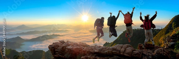 Fototapeta Group of happy hiker jumping on the hill