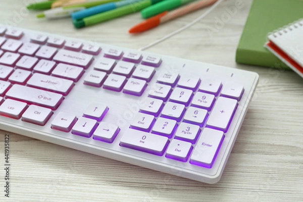 Obraz Modern RGB keyboard on white wooden table, closeup