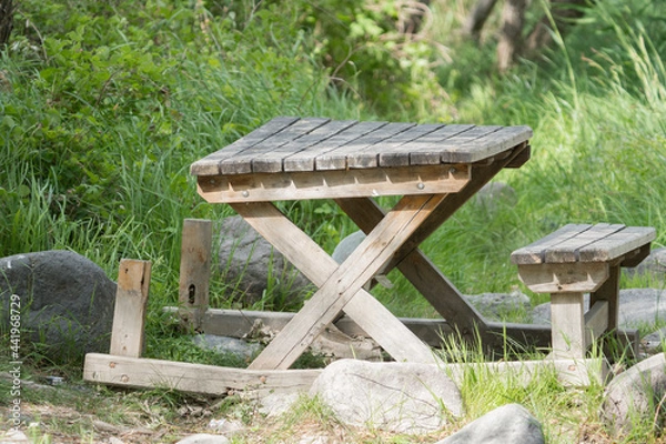 Fototapeta broken wooden picnic table in the forest