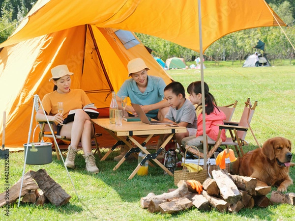 Obraz Happy family of four and dog camping out
