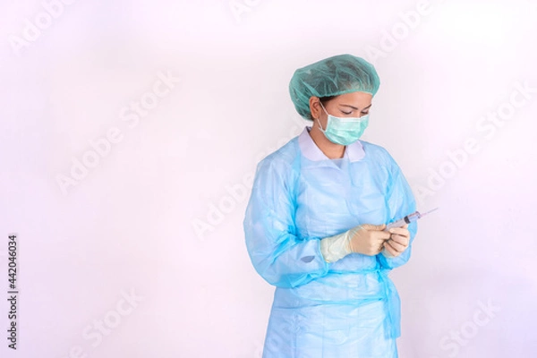 Fototapeta Hand of a nurse with a syringe on white background