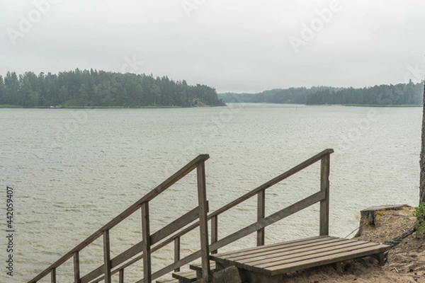 Obraz Wooden stairs to the seashore. Sandy beach, pine forest. Scandinavian nature. Finland. Porvoo