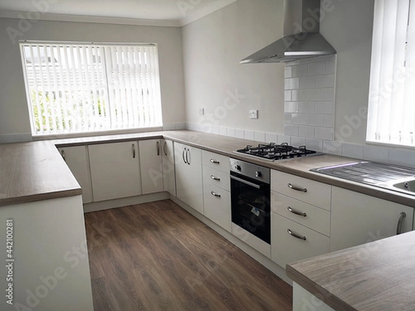 Obraz Kitchen counter with newly installed cooker and gas hob burners. Newly renovated house ready for sale or rental on the UK market.