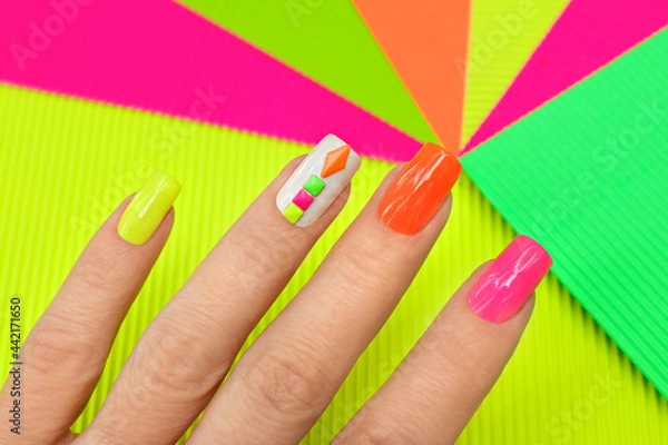 Obraz Bright illuminated multicolored manicure with rhinestones.