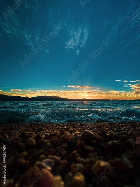 Fototapeta sunset on pebble beach