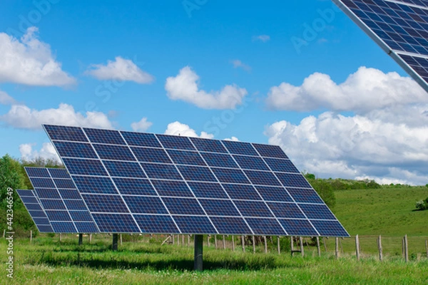 Fototapeta solar panel with green field