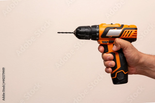 Obraz Hand with cordless drill with small drill bit