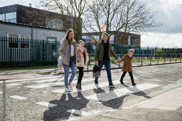 Fototapeta Family Walking Along Zebra Crossing