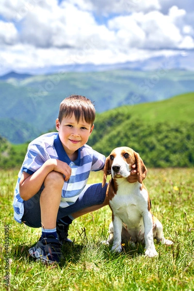 Fototapeta funny little boy with a dog in the mountains