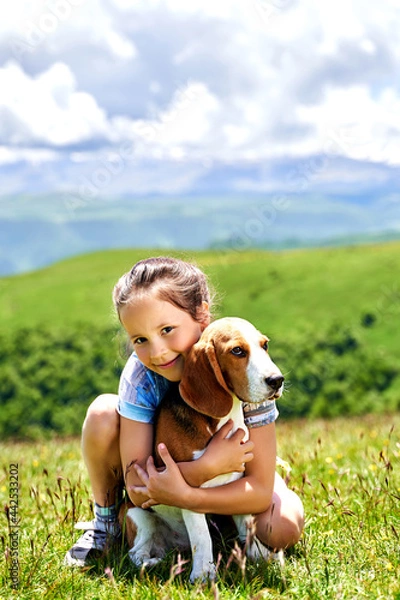 Fototapeta little funny girl with a dog in the mountains