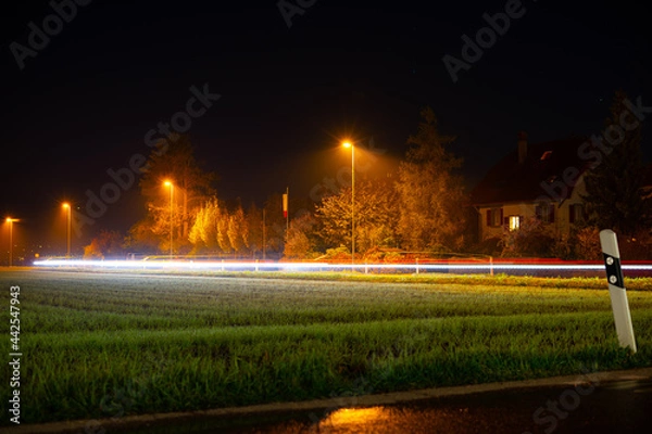 Fototapeta Lightrails auf einer Strasse