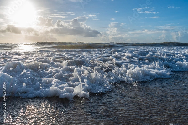 Obraz Rushing waves at beach with blue cloudy sky