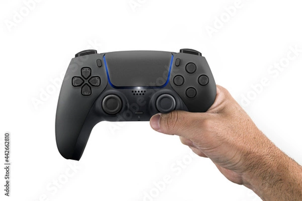 Fototapeta Male hand holding a Next Generation black game controller isolated on white background.