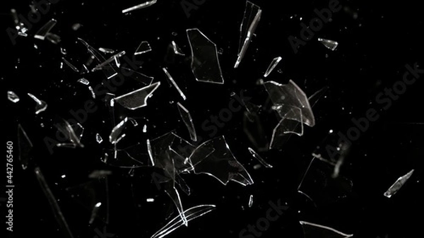Fototapeta Studio full-frame wide plate shot of window glass pane shattering and breaking on black background. Real smash explosion at high speed as action concept template and overlay element.