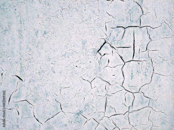 Obraz The texture of the painted wall in white and turquoise, which was covered with large black cracks. Concept background, texture
