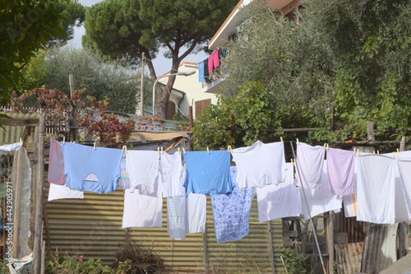 Fototapeta Clothes hanging outside to dry in a village in italy