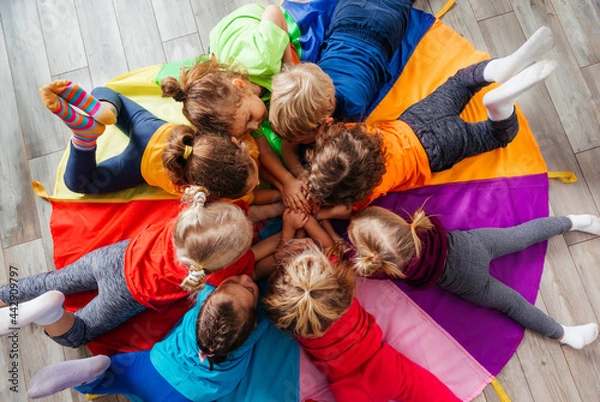 Obraz Cheerful children playing team building games on a floor
