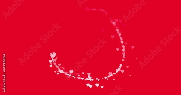 Fototapeta Trail of small pink hearts flying around on red background