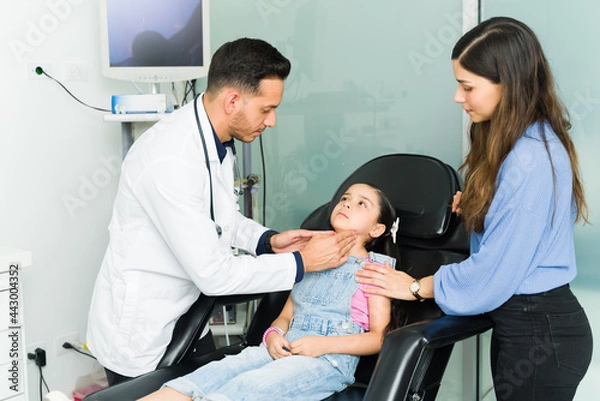 Fototapeta Woman with her child at the doctor for a check-up
