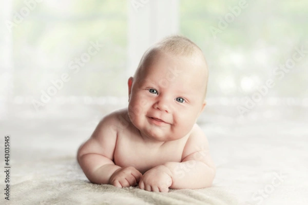 Obraz Three months old Caucasian boy lying on the belly with a raised head. Looking to the camera.