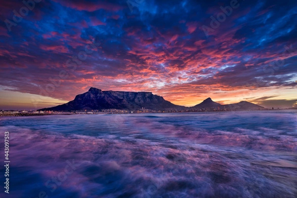 Obraz Beautiful sunset sky above a wispy long-exposure sea. Table Mountain sets the backdrop for a vibrant and colourful panorama