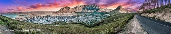 Obraz Dramatic and colourful sunset panorama of Table Mountain and the city bowl area, Cape Town South Africa. A unique wide-angle perspective from Signal Hill road  including some forest environment