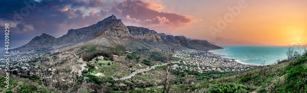 Fototapeta Stunning and scenic sunset panorama of Table Mountain range and the Twelve Apostles mountain, Cape Town South Africa. From the viewing point on Lion's Head a unique wide-angle perspective.