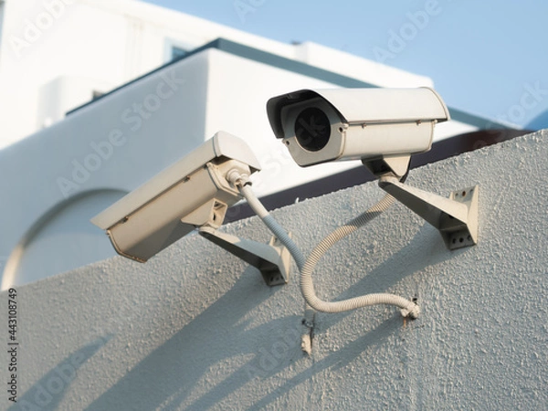 Obraz Old CCTV camera security on the concrete wall.