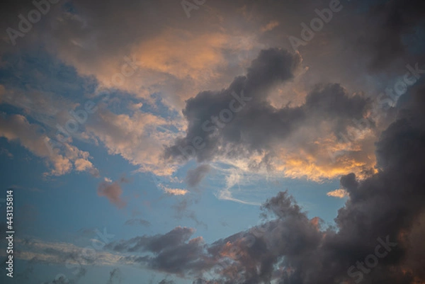 Fototapeta a dark thundercloud on the background of sunset