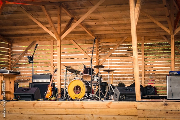 Fototapeta An open-air music stage with musical instruments and sound equipment.