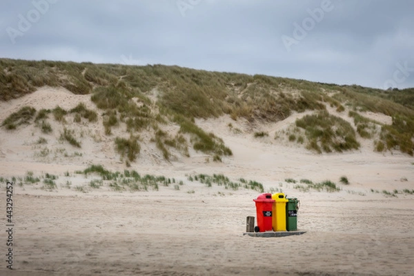 Fototapeta Garbage bin on the beach, Beach and dunes desolate nobody  only three colorful trash cans red yellow and green