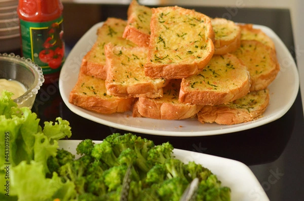 Fototapeta Western Food Dish Background with garlic bread, donuts, vegetables, french fries, slices fried chicken and slices beef steak