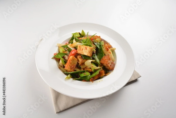 Fototapeta stir fried vegetable with bean curd tofu in spicy sambal chilli sauce in white plate asian halal menu