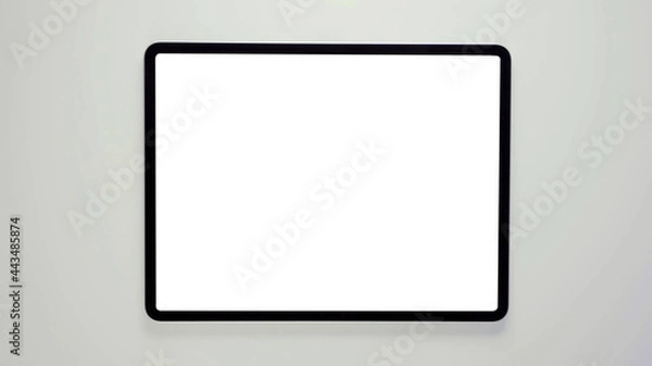 Fototapeta A tablet with black frame and blank white screen, isolated modern real tab computer 3D with copy space mockup.
