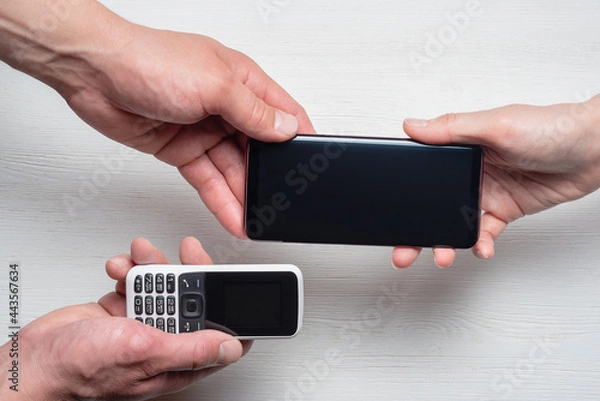 Fototapeta Buying a new smartphone trade in concept. Exchange of an old phone for a new one concept.