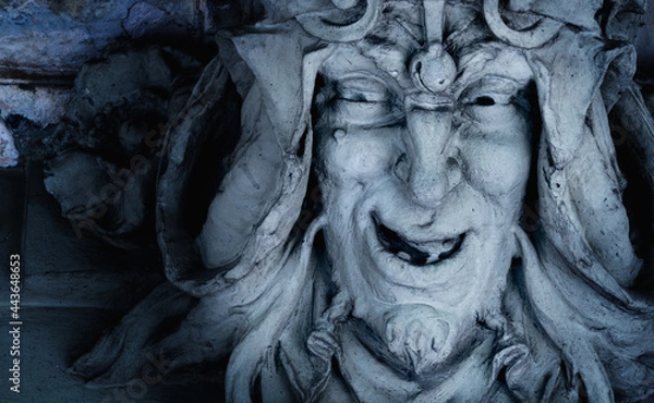 Obraz Monster face of aGreek antique god daimon of eager rivalry, envy, jealousy, and zeal Zelus (Zelos). Fragment of an ancient stone statue. Horizontal image.