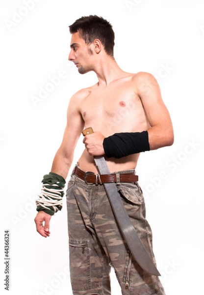 Obraz Young fighter holding a machete