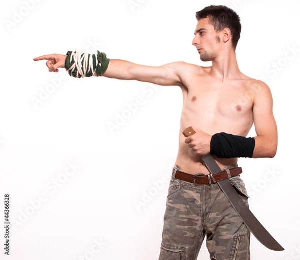 Obraz Young fighter holding a machete