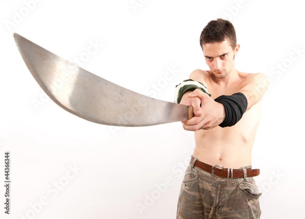 Obraz Young fighter holding a machete