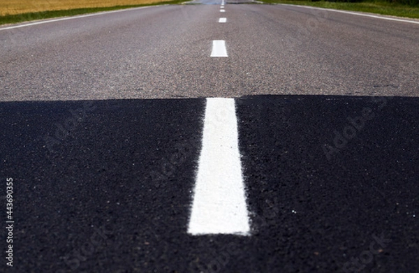 Fototapeta part of the old and new asphalted road