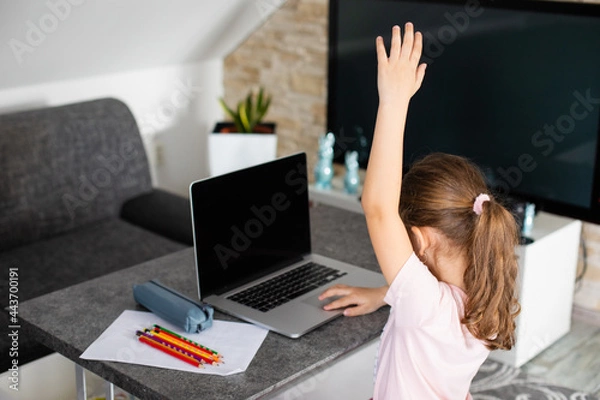 Obraz Little girl is back to school with the mask on her face, online education