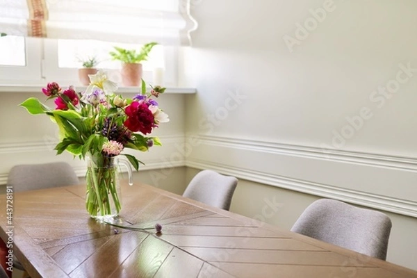 Fototapeta Bouquet of bright flowers on the table in jug