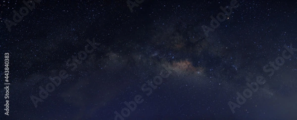 Fototapeta Milky way in the night sky and stars on dark background with noise and grain. Photo taken with long exposure and white balance selected.
