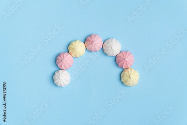 Obraz Sweet meringue cookies arranged in semi-circle. Pastel colors. Minimal concept flat lay.