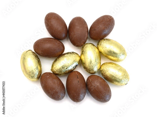 Obraz Chocolate easter eggs in colorful foil on white background